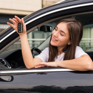 happy-young-smiling-woman-with-new-car-key-scaled-300x300-1